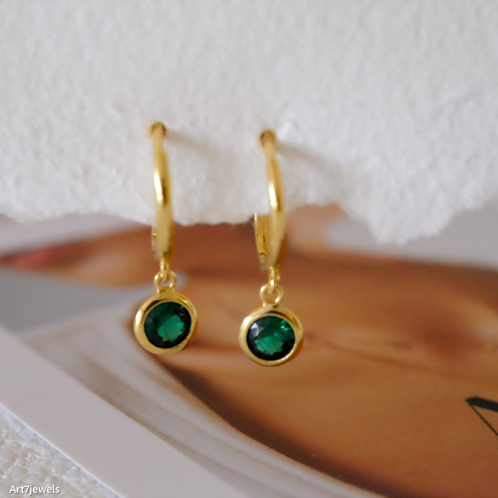 Dainty emerald huggie earrings