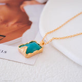 Necklace with a amazonite pendant on a white surface