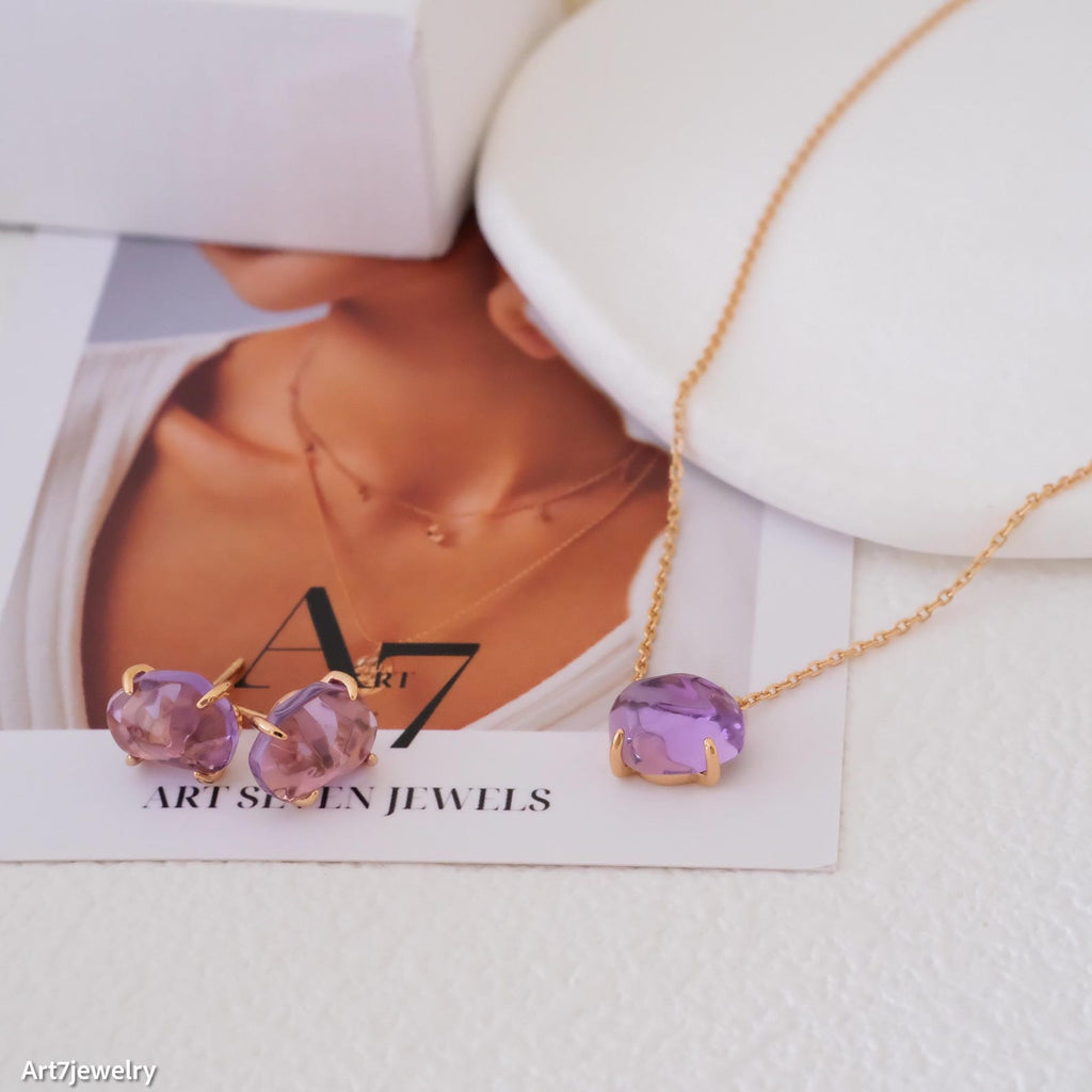 Purple gemstone jewelry set on a card with 'Art Seven Jewels' branding.