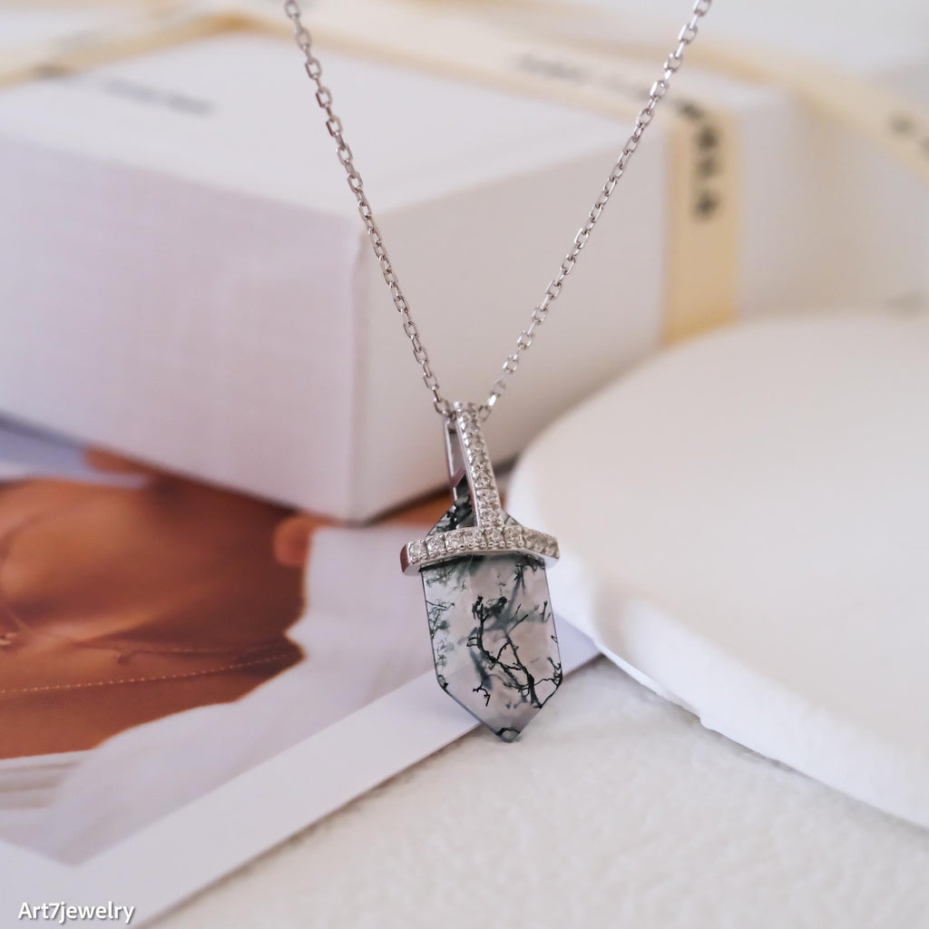 Necklace with moss agate pendant on a magazine background