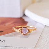 Natural amethyst ring featuring a genuine light purple oval amethyst gemstone set in a delicate gold leaf band, nature inspired February birthstone jewelry for women.