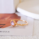 Natural amethyst ring featuring a genuine light purple oval amethyst gemstone set in a delicate gold leaf band, nature inspired February birthstone jewelry for women.