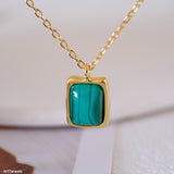 Natural malachite necklace featuring a genuine rectangular green malachite gemstone with distinctive banding in a polished gold bezel pendant on a delicate gold chain, elegant minimalist gemstone jewelry for women.