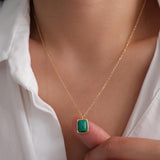 Natural malachite necklace featuring a genuine rectangular green malachite gemstone with distinctive banding in a polished gold bezel pendant on a delicate gold chain, elegant minimalist gemstone jewelry for women.