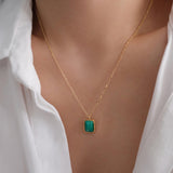 Natural malachite necklace featuring a genuine rectangular green malachite gemstone with distinctive banding in a polished gold bezel pendant on a delicate gold chain, elegant minimalist gemstone jewelry for women.