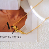 Natural peridot necklace featuring five genuine marquise-cut green peridot gemstones in a delicate curved gold bar design on a fine gold chain, elegant August birthstone jewelry for women.