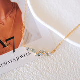 Natural aquamarine necklace featuring five genuine marquise-cut aquamarine gemstones in a delicate curved gold bar design on a fine gold chain, elegant March birthstone jewelry for women.