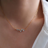 Natural aquamarine necklace featuring five genuine marquise-cut aquamarine gemstones in a delicate curved gold bar design on a fine gold chain, elegant March birthstone jewelry for women.