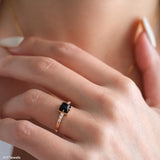 Square black onyx ring in a detailed gold-tone setting with sparkling clear stone accents along the band.
