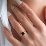 Square black onyx ring in a detailed gold-tone setting with sparkling clear stone accents along the band.