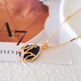 Close up of blue gemstone with gold filigree crown setting and pave crystals