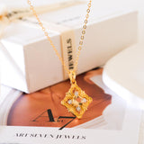 Gold-tone citrine clover pendant necklace with a faceted yellow center stone and sparkling clear stone accents.