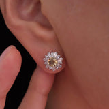 Citrine sunflower stud earrings with golden-yellow center stones and clear baguette-cut halo accents.