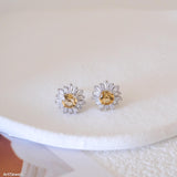 Citrine sunflower stud earrings with golden-yellow center stones and clear baguette-cut halo accents.