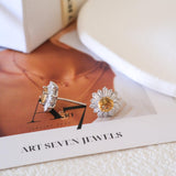 Citrine sunflower stud earrings with golden-yellow center stones and clear baguette-cut halo accents.