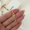 Natural citrine bracelet featuring a genuine golden yellow citrine gemstone surrounded by a sparkling halo, set on a delicate gold chain with bezel accents, elegant November birthstone jewelry for women.