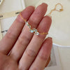 Natural aquamarine necklace featuring five genuine marquise-cut aquamarine gemstones in a delicate curved gold bar design on a fine gold chain, elegant March birthstone jewelry for women.