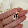 Close up of blue gemstone with gold filigree crown setting and pave crystals